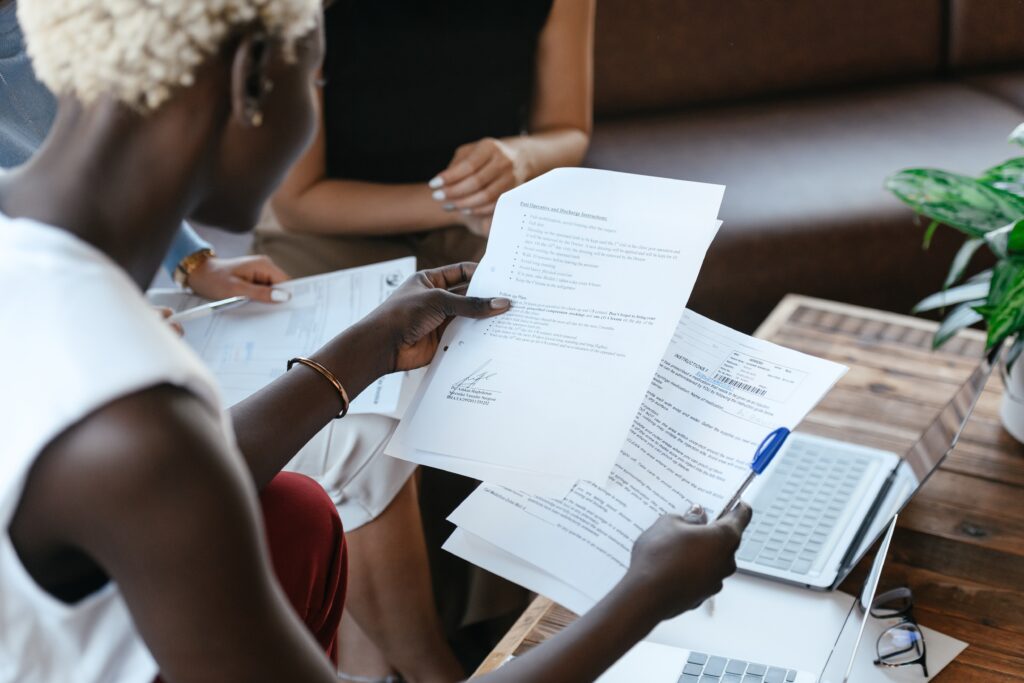 A black woman reading information off an important document