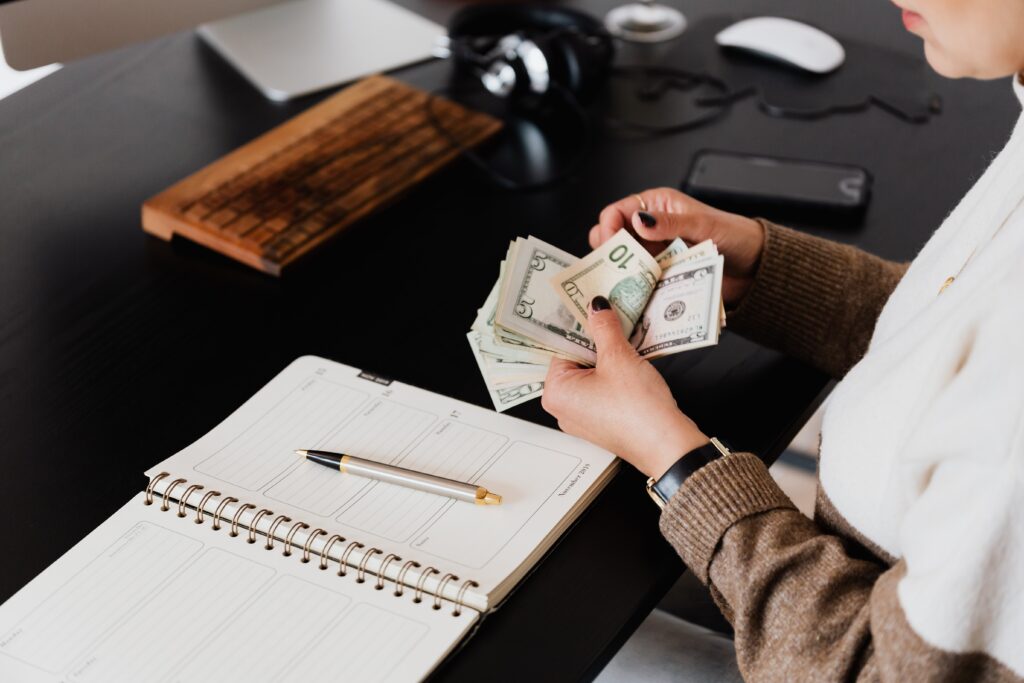 A person counting money at a desk