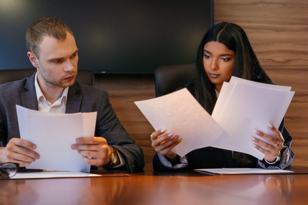 Two people looking through documents: outsourced accountant