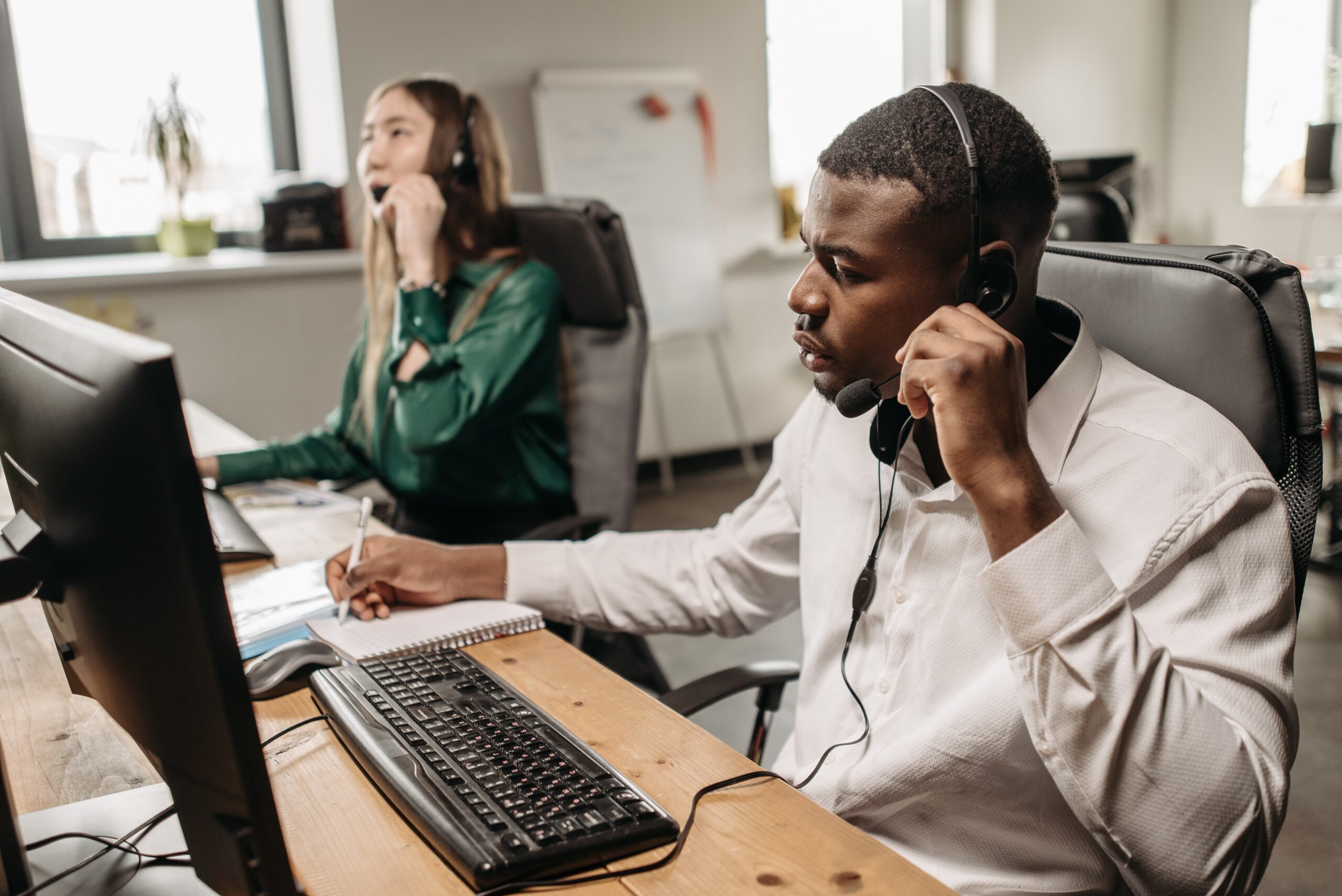 Two people answering calls: outsourcing functions