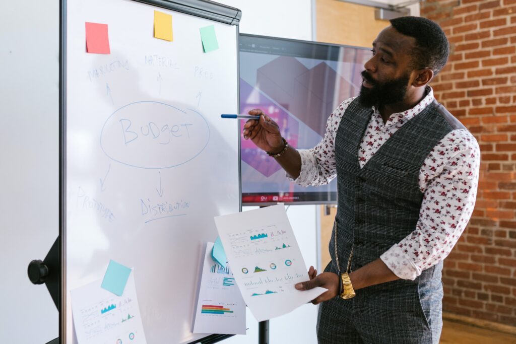 A man making a presentation on a whiteboard