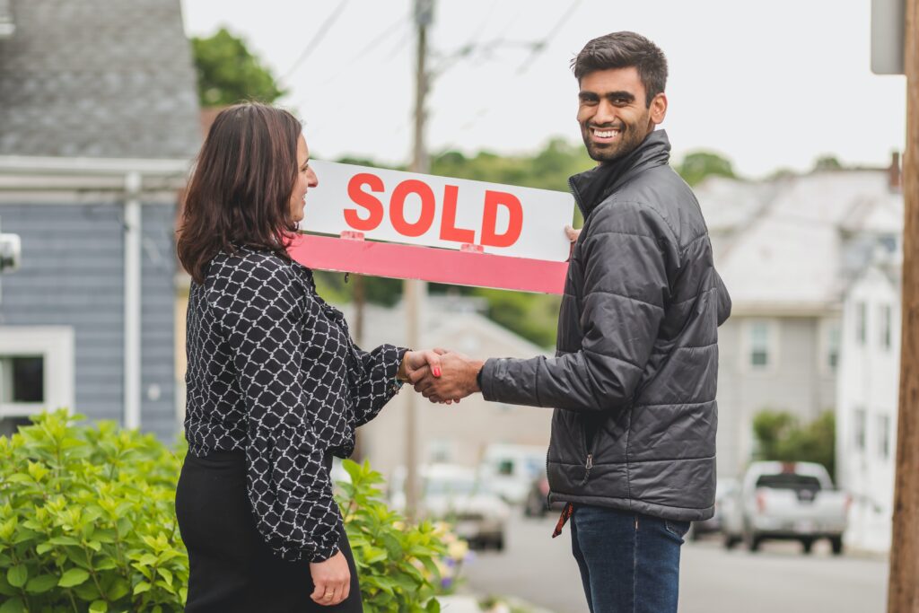 A man in a black jacket closing a deal with an agent