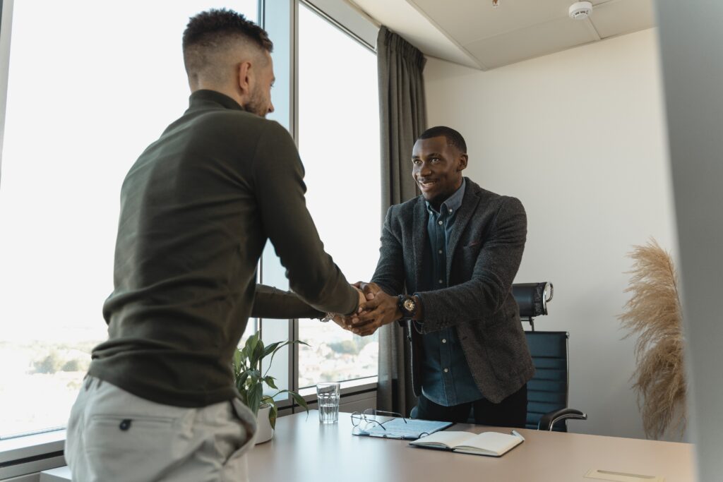 Two men shaking hands: outsourcing services