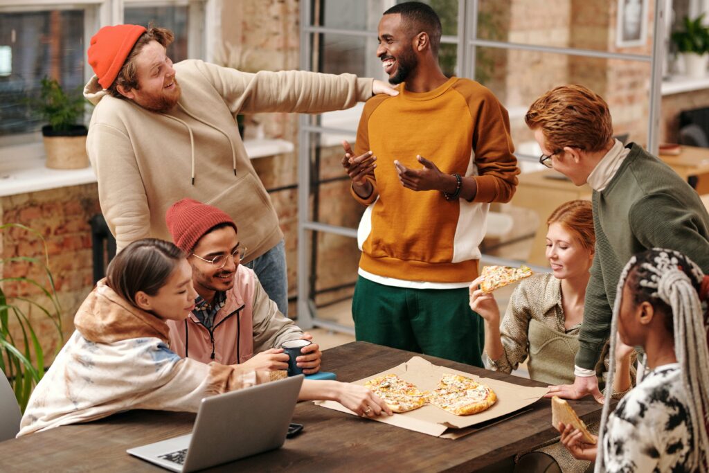 People having a discussion around a table: outsourced marketing