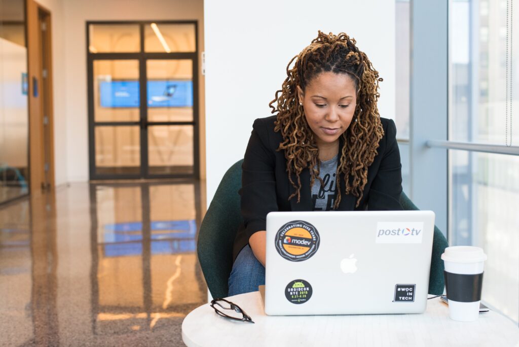 Woman in black blazer sitting on chair using laptop: outsourced call centre