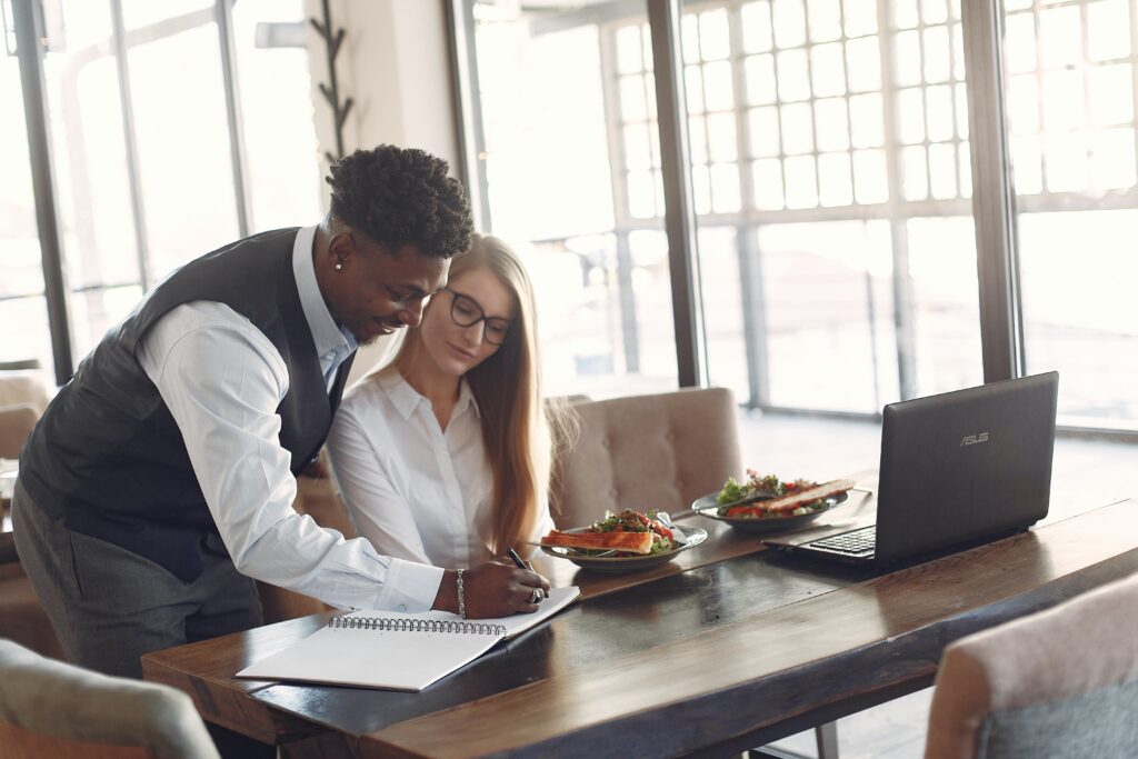 Two employees working together on something: outsourced project manager