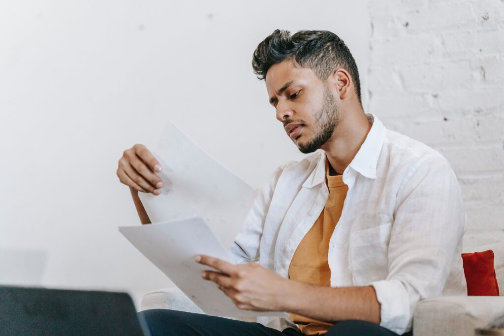A man reading a document at a desk: outsourced sales representative