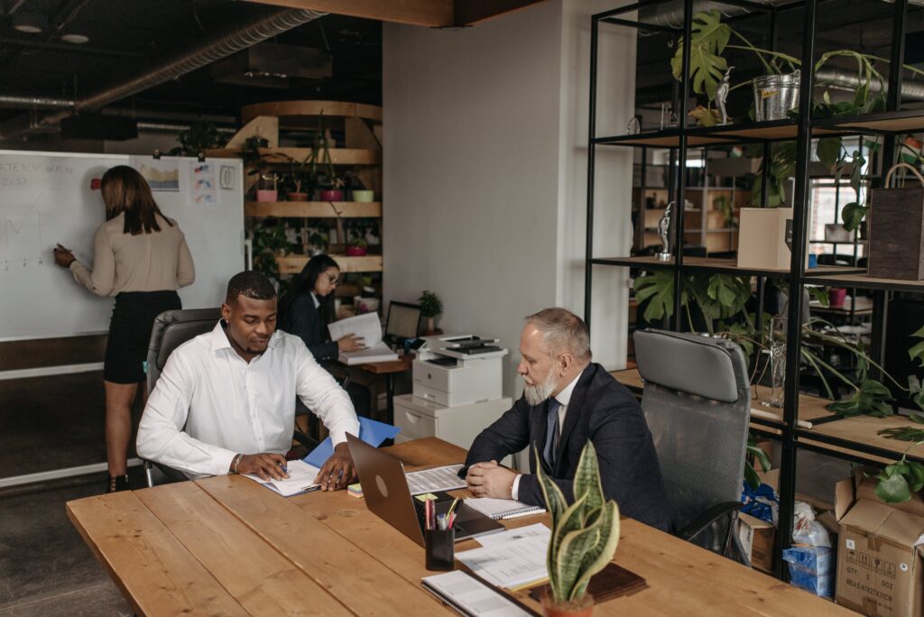 Two men having a a meeting in an office: outsourced sales representative