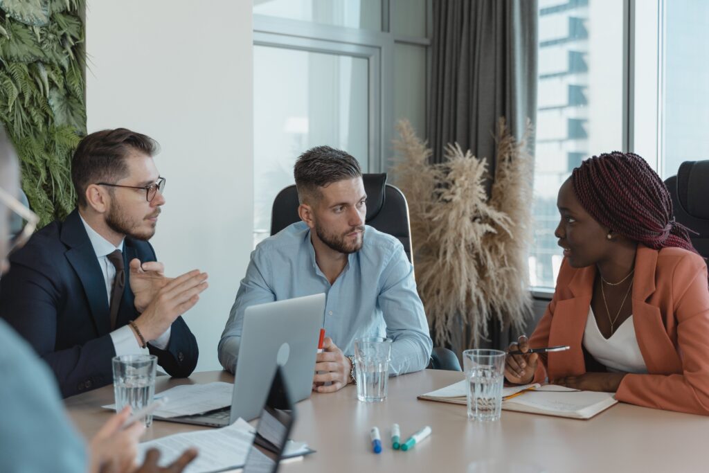 Colleagues having a meeting at a table: outsourcing risk management